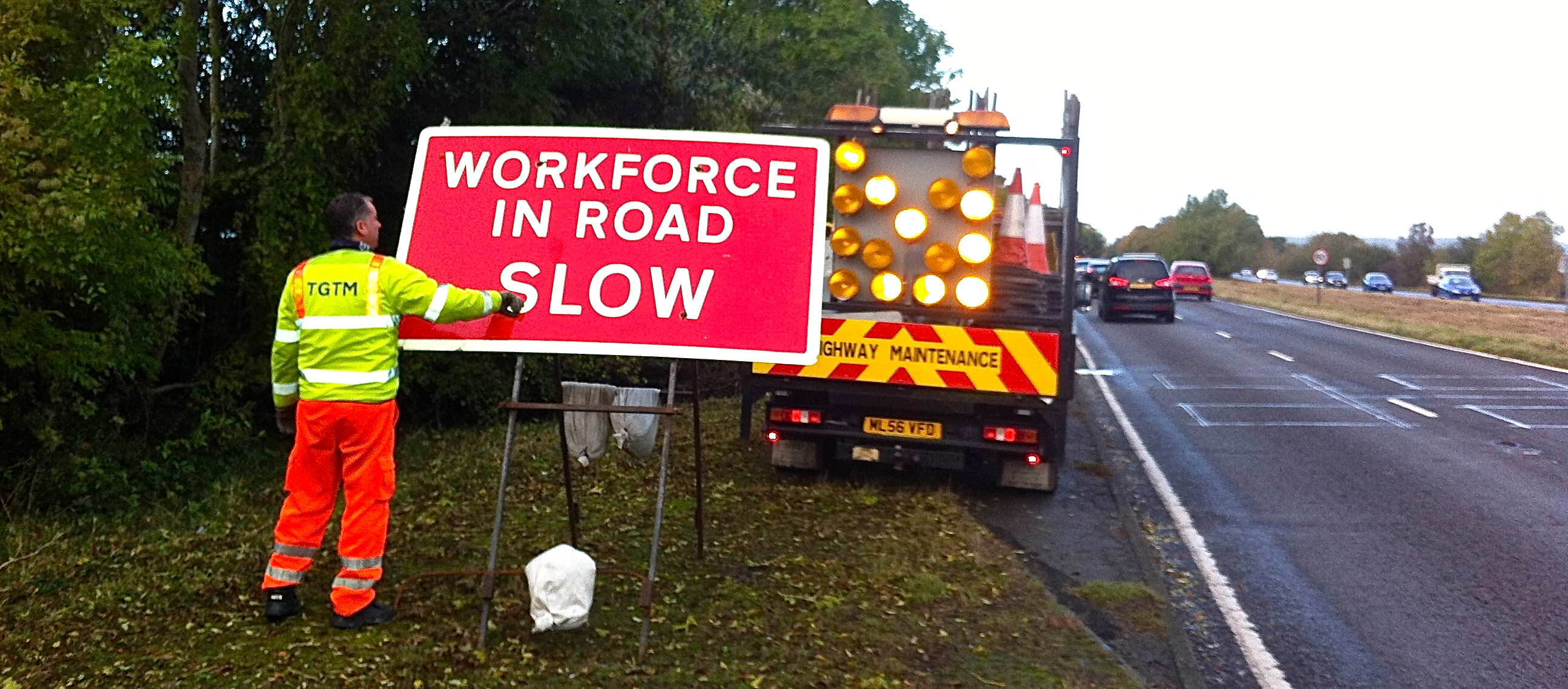Workforce in Road Slow sign Implementation with Light Arrow Van.